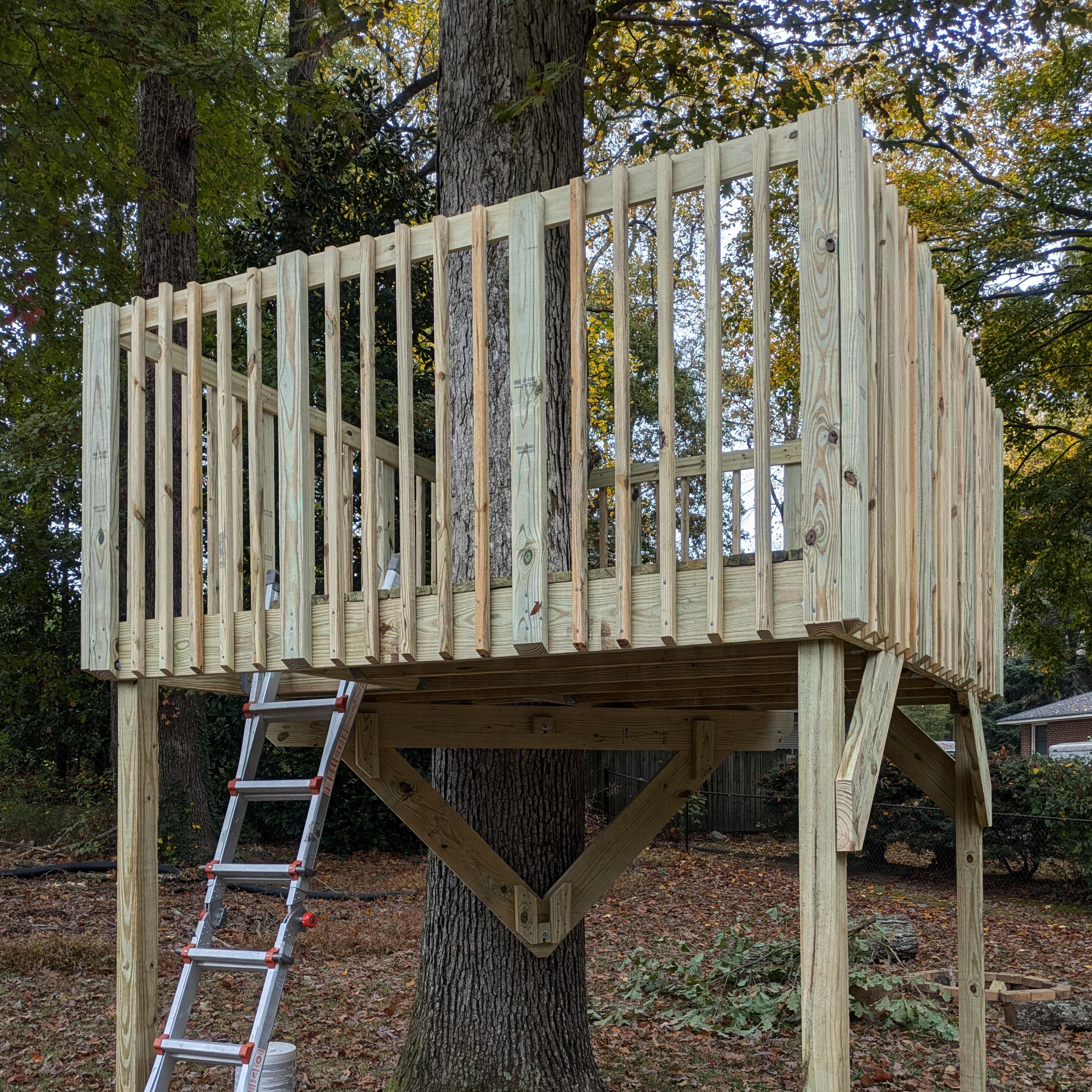 The completed railing, shown from the trap door side of the treehouse. Each side has four evenly-spaced 2x4 balusters, with five evenly-spaced 2x2 balusters between each pair, and a 1x4 banister on the inside edge of the top.