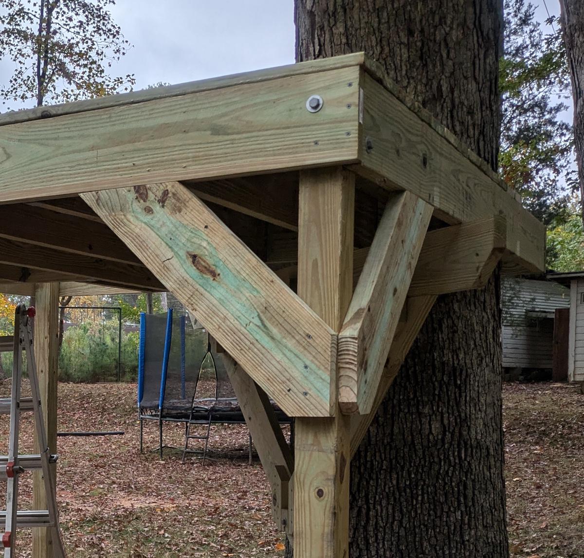 Two diagonal supports attached to a single post, connecting to the two sides of the joist frame adjacent to it.