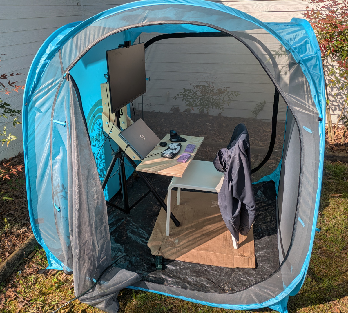 My tripod desk inside a cube-shaped screen tent.